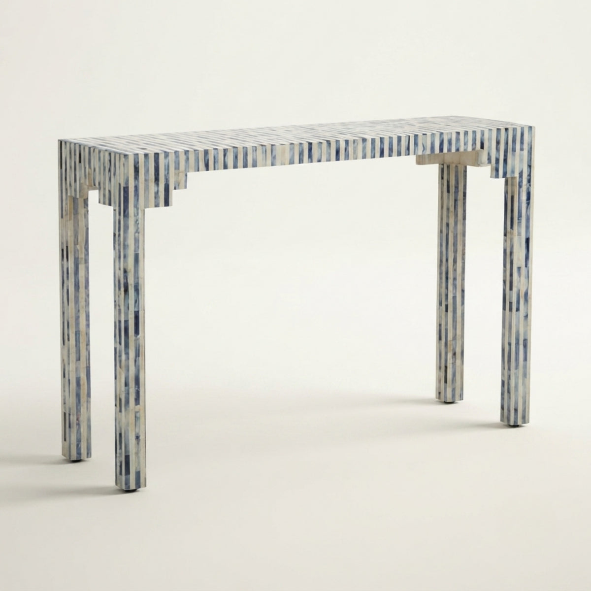 A modern console table with a rectangular top and four legs, featuring a blue and white marbled bone inlay pattern, photographed against a clean off-white background.