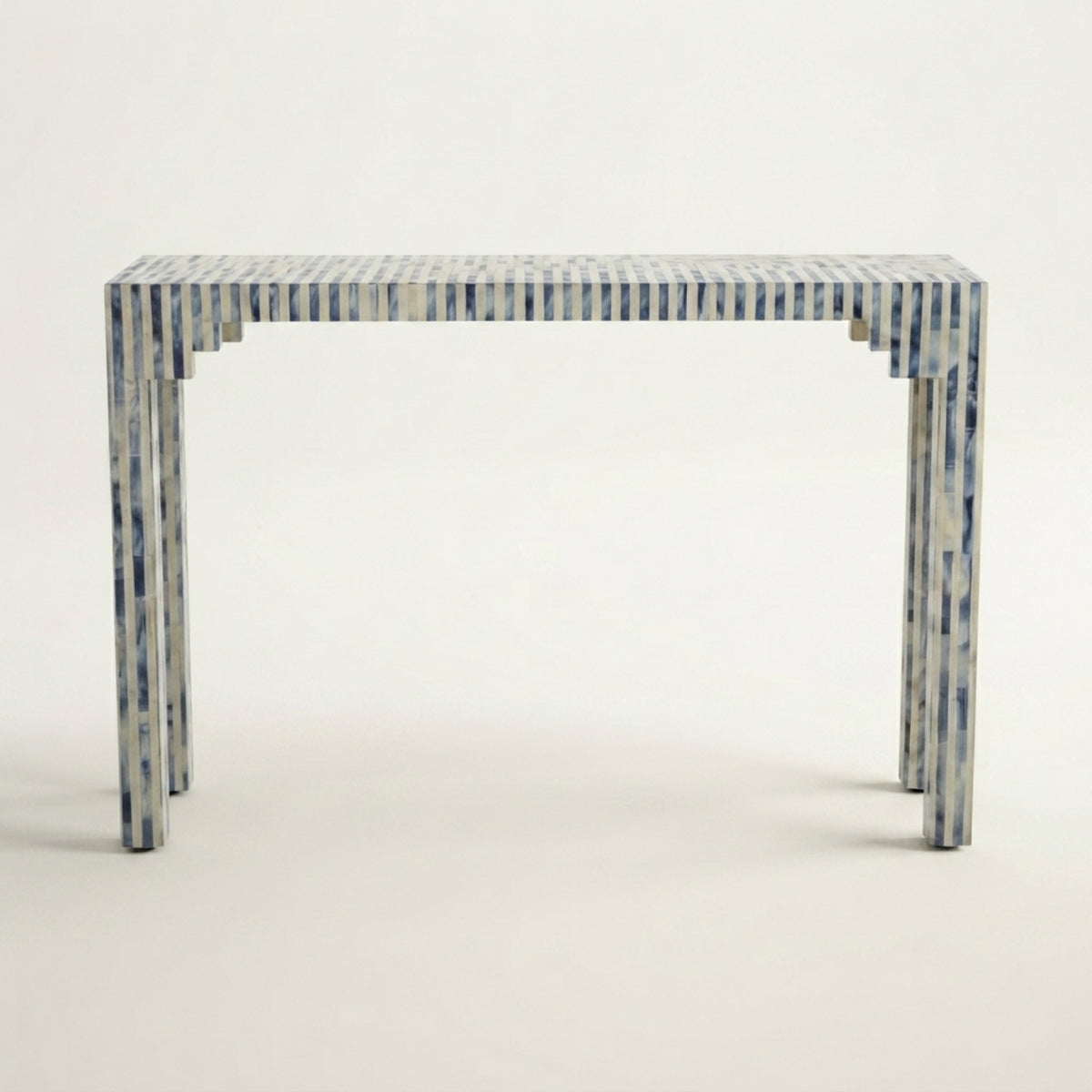 A rectangular console table with a blue and white striped bone-inlay finish, shown from a front-three-quarter angle against a plain off-white background.