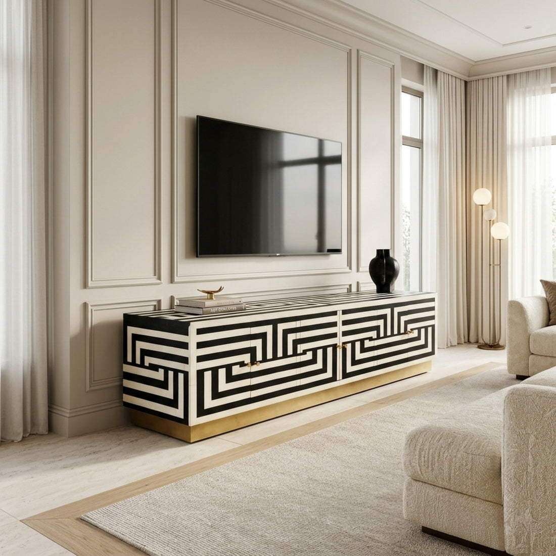 A rectangular sideboard cabinet with a black and off-white Greek key geometric pattern and a gold base, photographed on a clean white studio background.