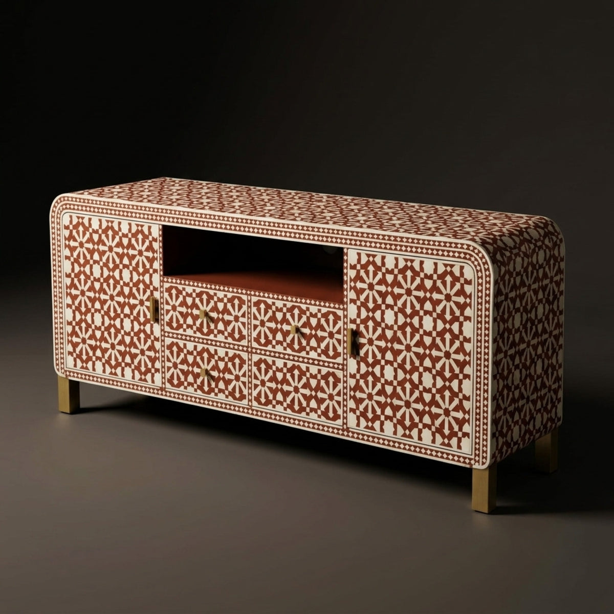 A modern media console cabinet featuring an intricate geometric bone-inlay pattern in terracotta red and cream, with small brass handles and gold-toned legs, set against a dark studio background.