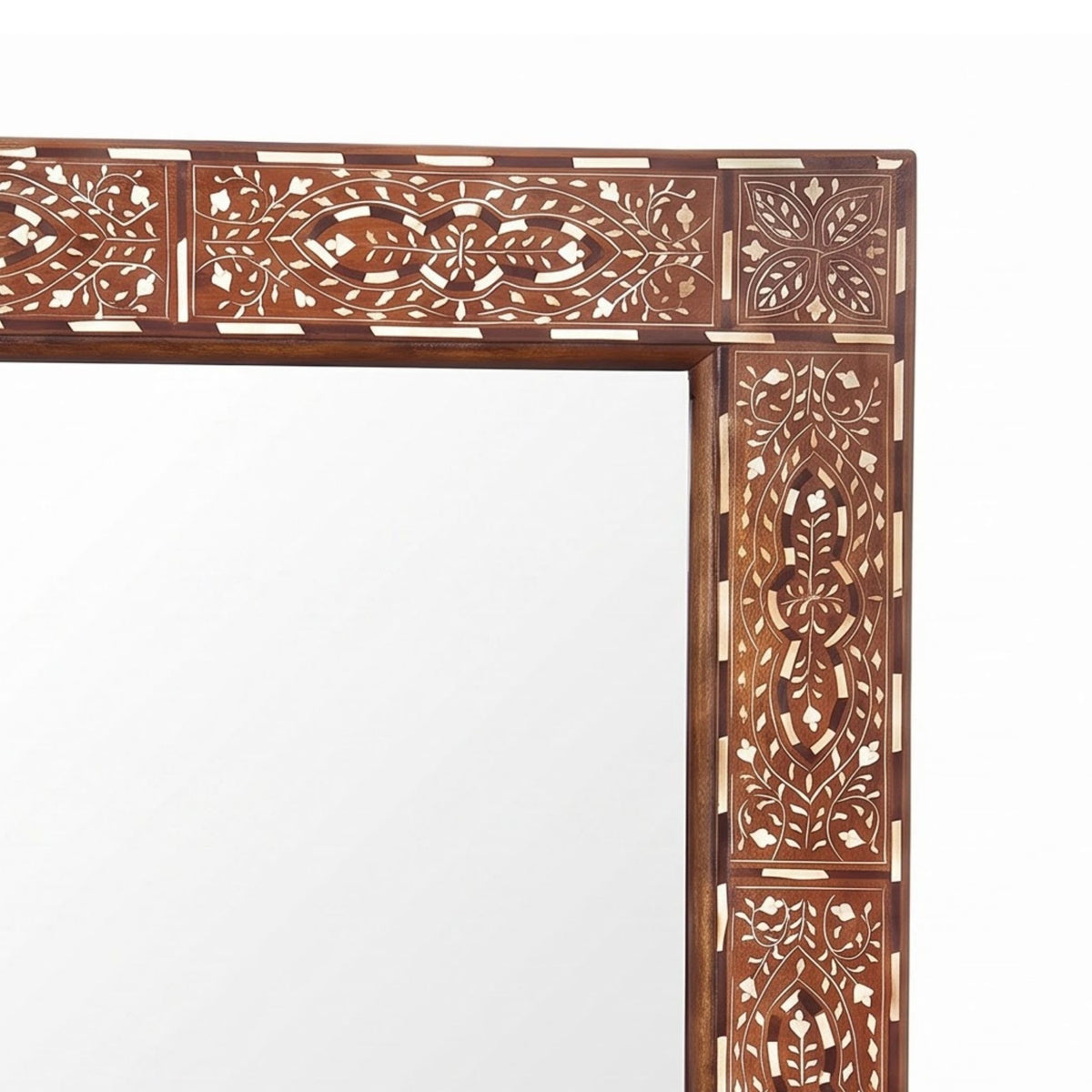 An ornate rectangular mirror with an intricately carved wooden frame featuring floral and geometric inlay patterns in warm brown and cream tones, shown against a plain white background.