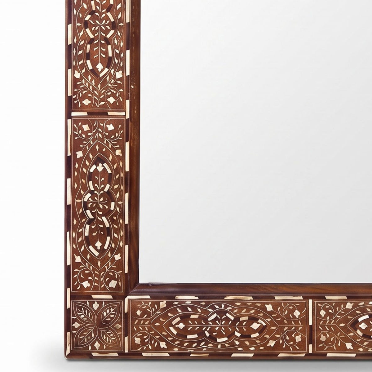 An ornate rectangular mirror with an intricately carved wooden frame featuring geometric and floral patterns in dark brown and light beige inlay, shown against a plain white background.