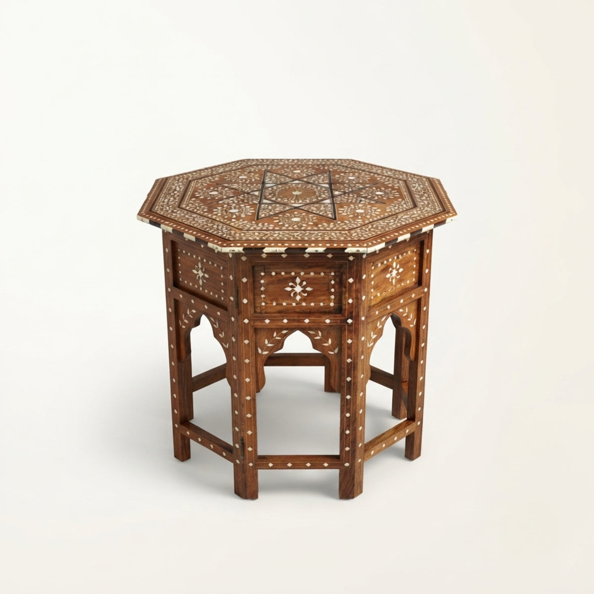 An octagonal wooden side table with intricate white bone or mother-of-pearl inlay patterns on the top and drawer front, set against a plain white background.
