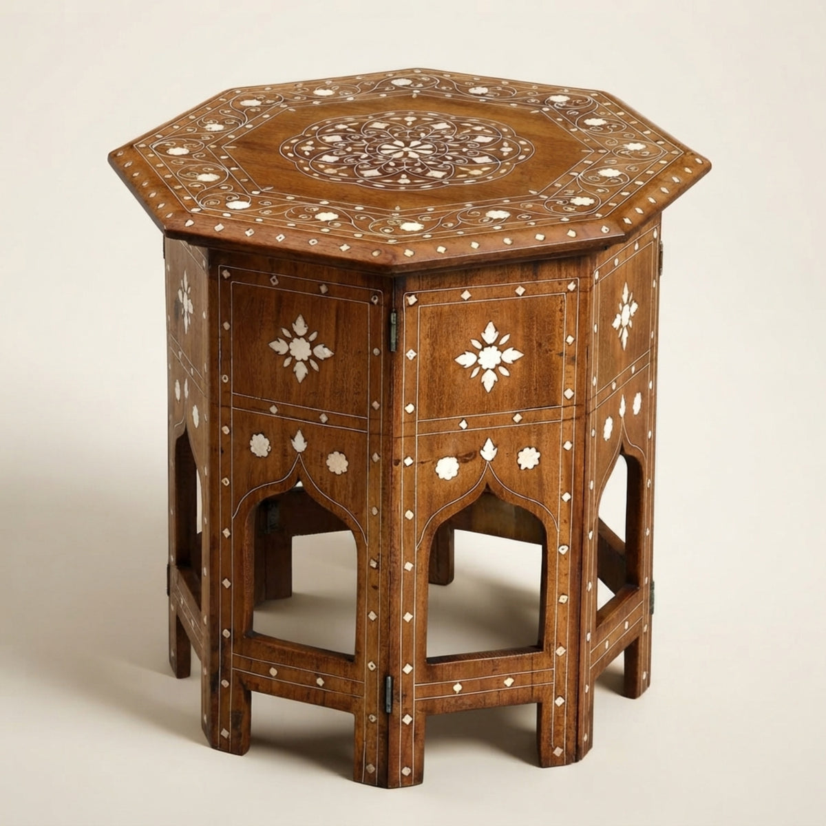 An octagonal wooden side table with intricate white and brown inlay patterns, photographed on a neutral light beige background.