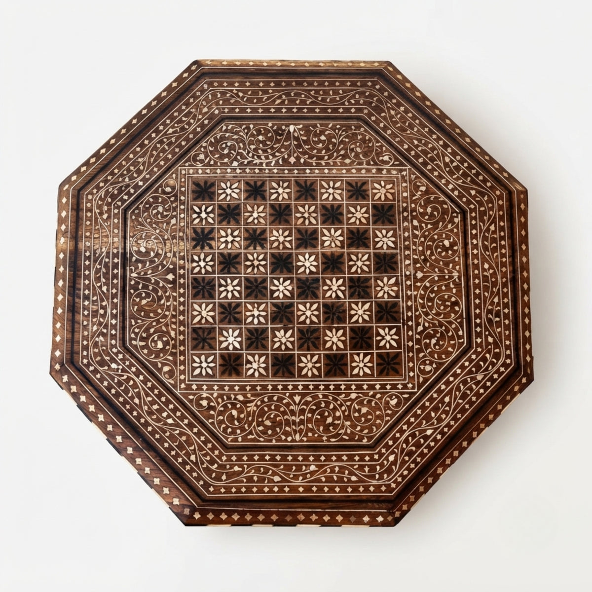 An octagonal wooden board featuring intricate hand-painted floral and geometric patterns in dark brown and light beige, photographed from directly above on a clean white background.