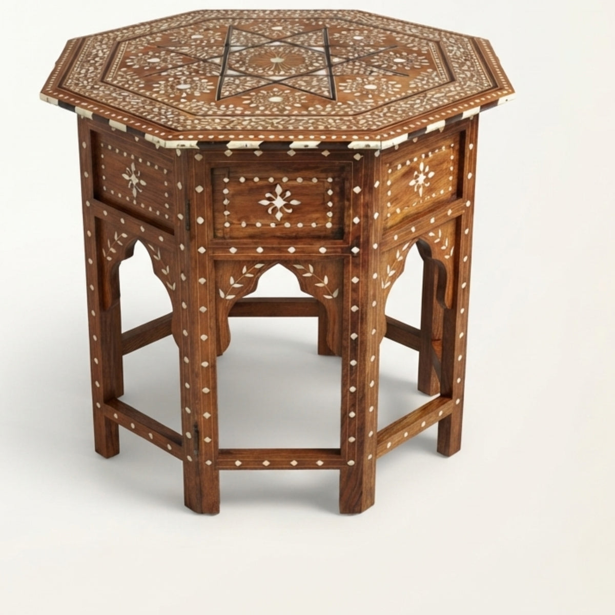 An octagonal wooden side table with intricate white bone or mother-of-pearl inlay patterns, featuring a single drawer and three arched legs, shown on a light gray background.