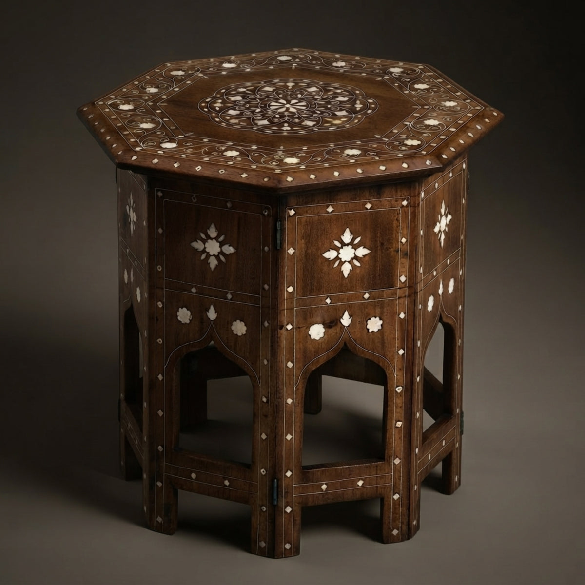 An octagonal dark brown wooden side table with intricate white bone or mother-of-pearl inlay patterns, photographed against a dark gray studio background.