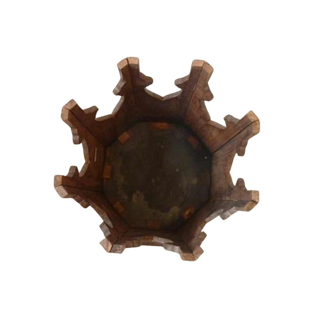 A rustic dark brown wooden bowl with a highly decorative, multi-pointed fluted rim, shown from a top-down perspective on a solid white background.