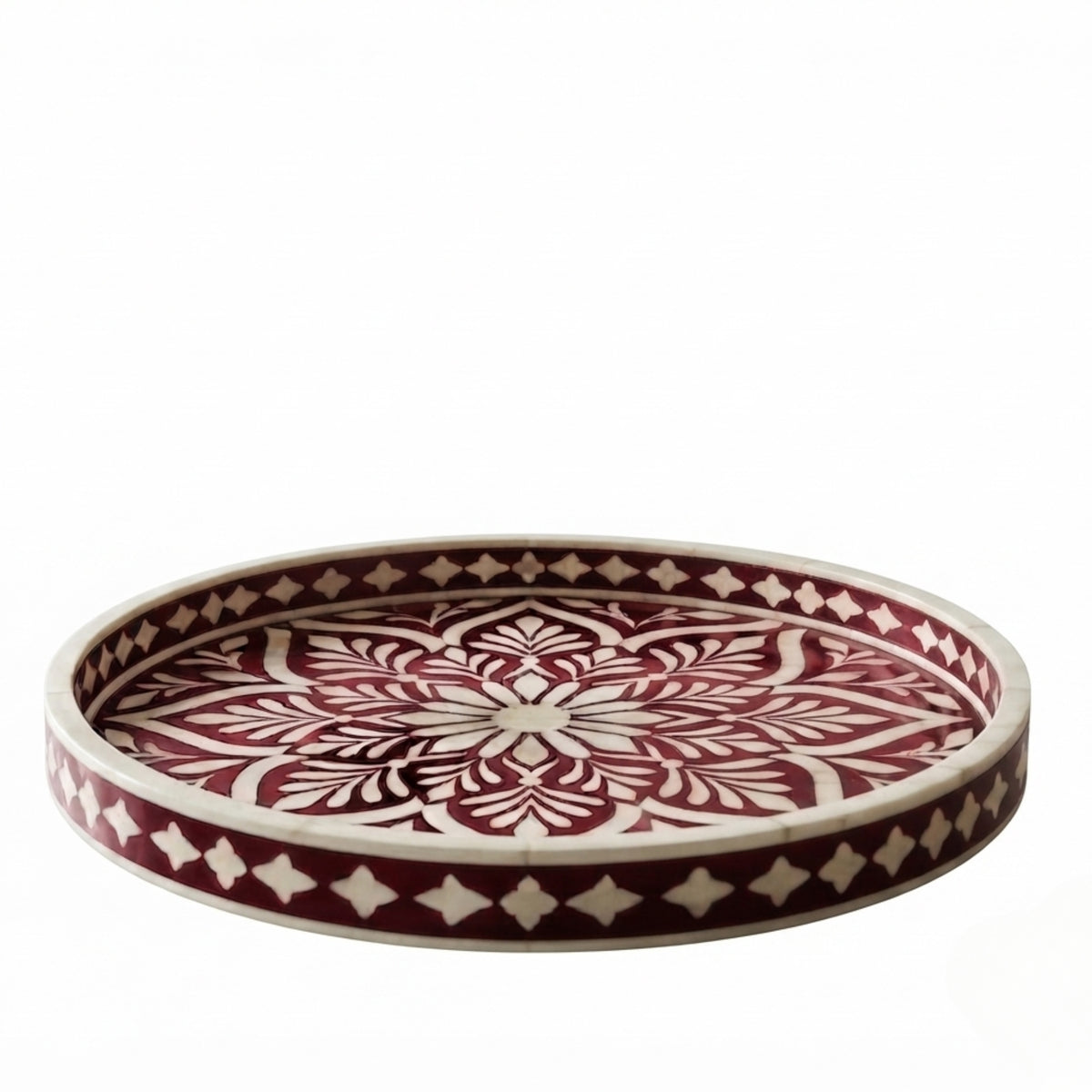 A round decorative tray with a carved bohemian mandala pattern in dark red and cream, shown on a plain white background.
