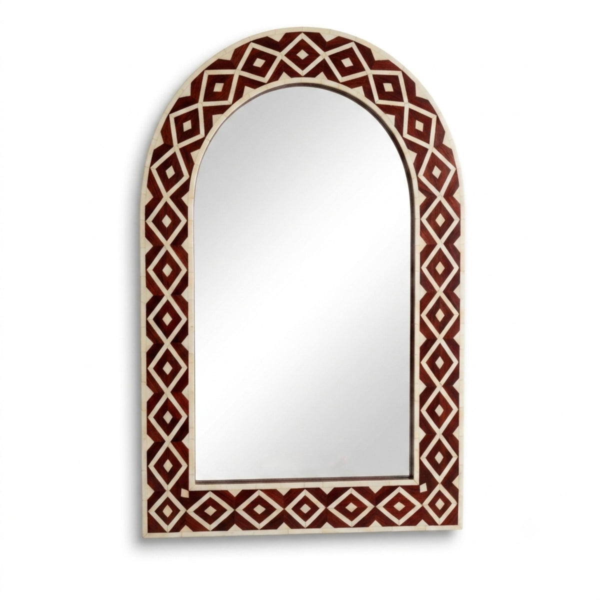 An arched wall mirror with a decorative border featuring a repeating diamond pattern in dark red and cream.