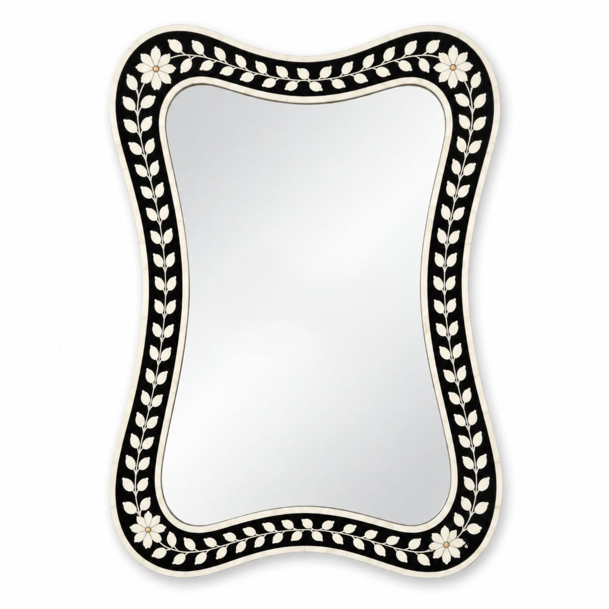 A decorative wall mirror with a wavy, asymmetrical silhouette and an inlay border featuring a black background, white floral motifs, and white leafy vines.