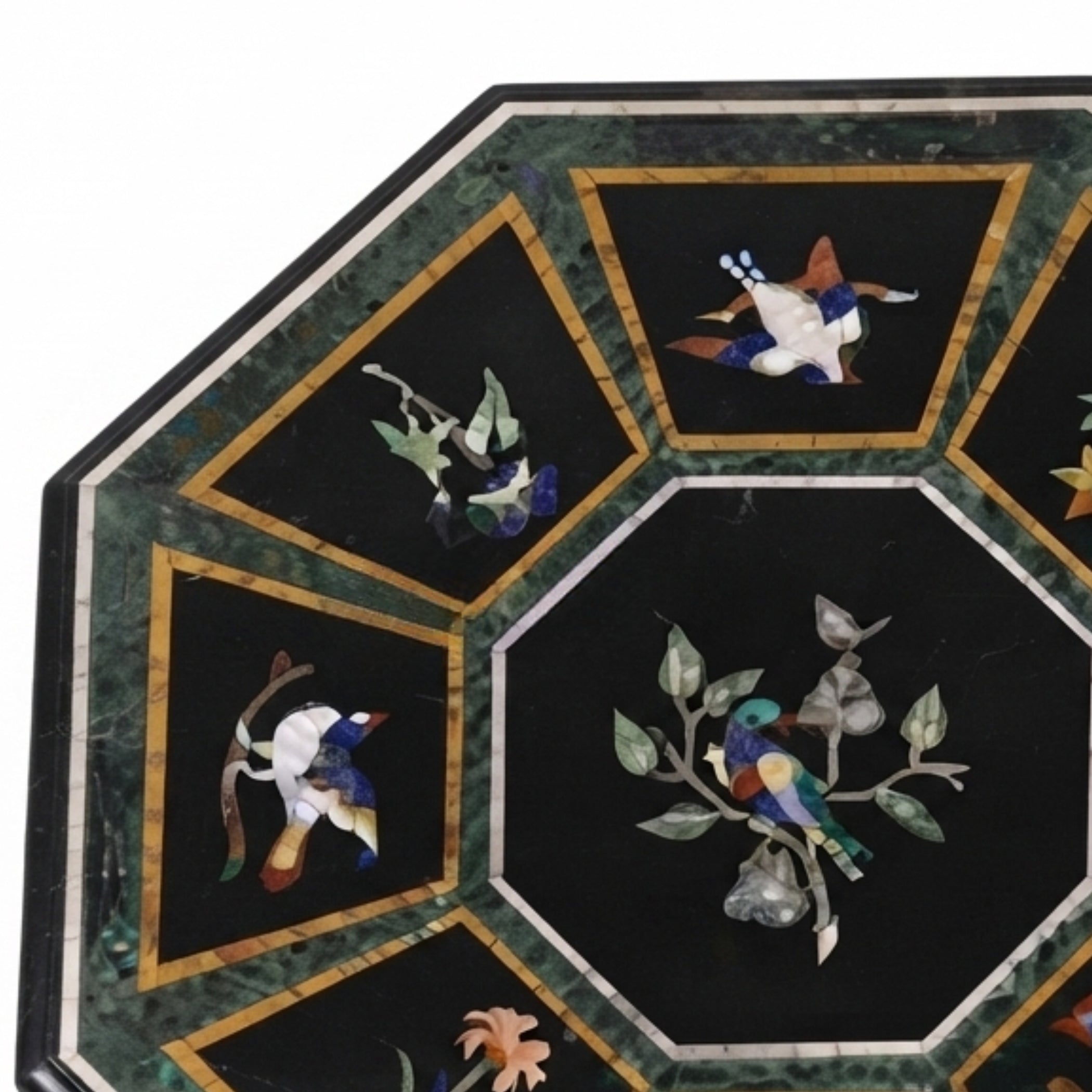 Close-up of handcrafted bird and floral pietra dura gemstone inlay on a black marble octagonal table top showcasing artisan craftsmanship and intricate details.