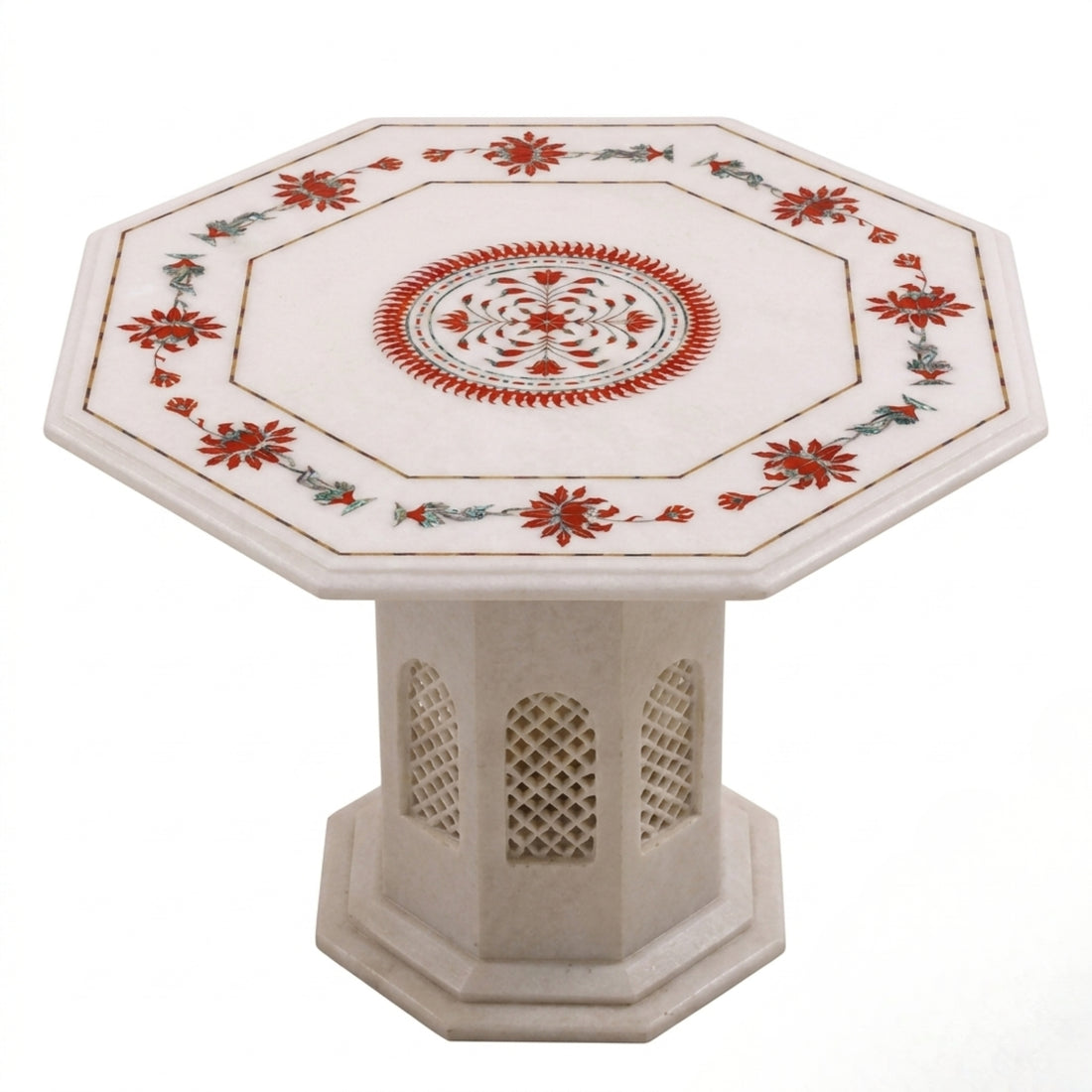 An octagonal cream-colored stone coffee table with a decorative red and white patterned top, styled in a bright, modern living room next to a beige sofa.