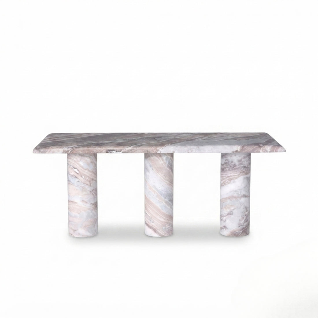 A modern rectangular coffee table with a polished marble top and three carved stone legs, styled in a warm, neutral-toned living room next to a boucle sofa.