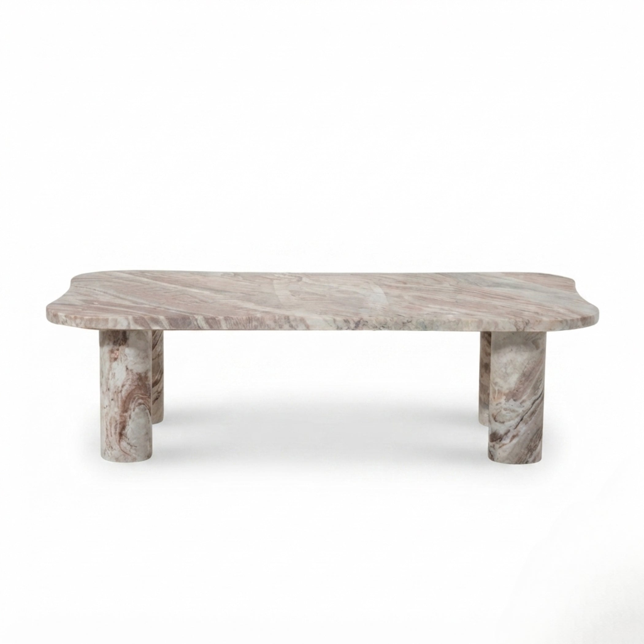 A modern low coffee table made of natural pinkish-gray marble with distinctive wavy edges and cylindrical block legs, shown against a plain white background.