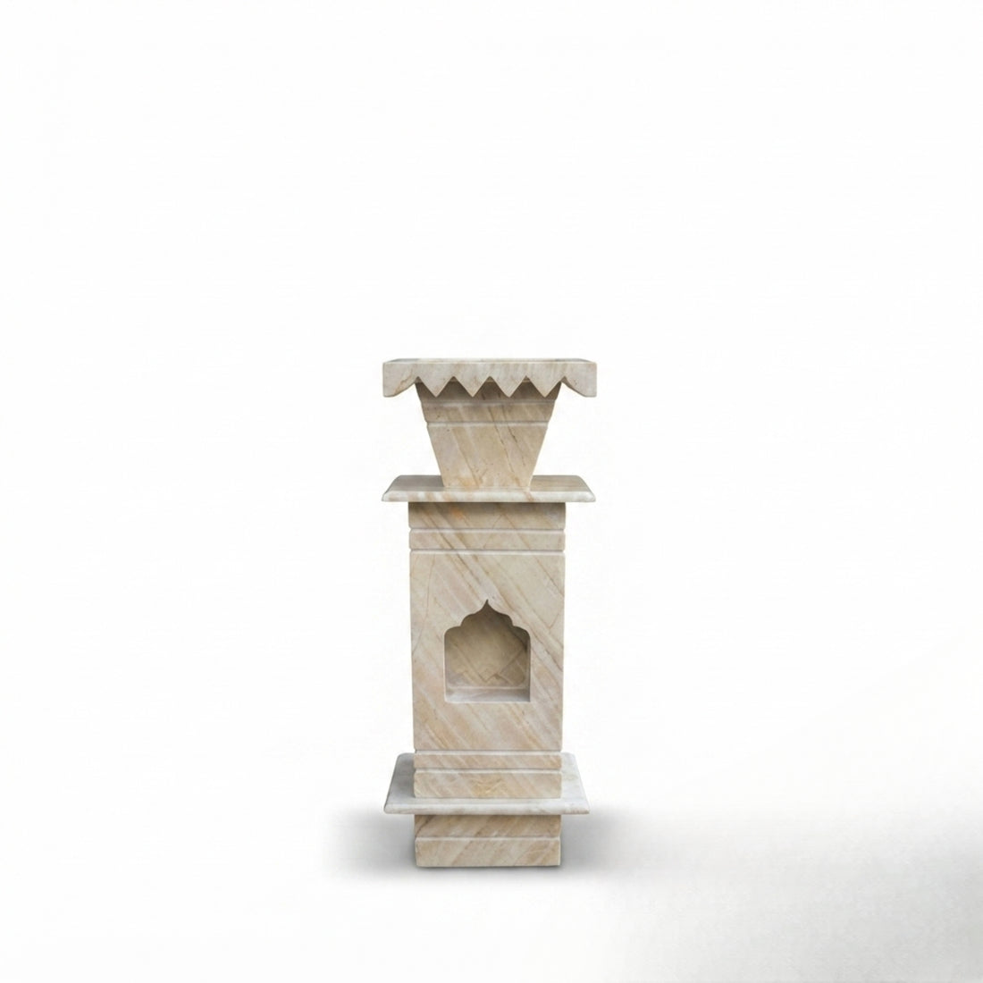 A tall marble planter stand holding a potted olive tree, set in a sunlit Mediterranean-style courtyard with arches, potted plants, and a lantern.
