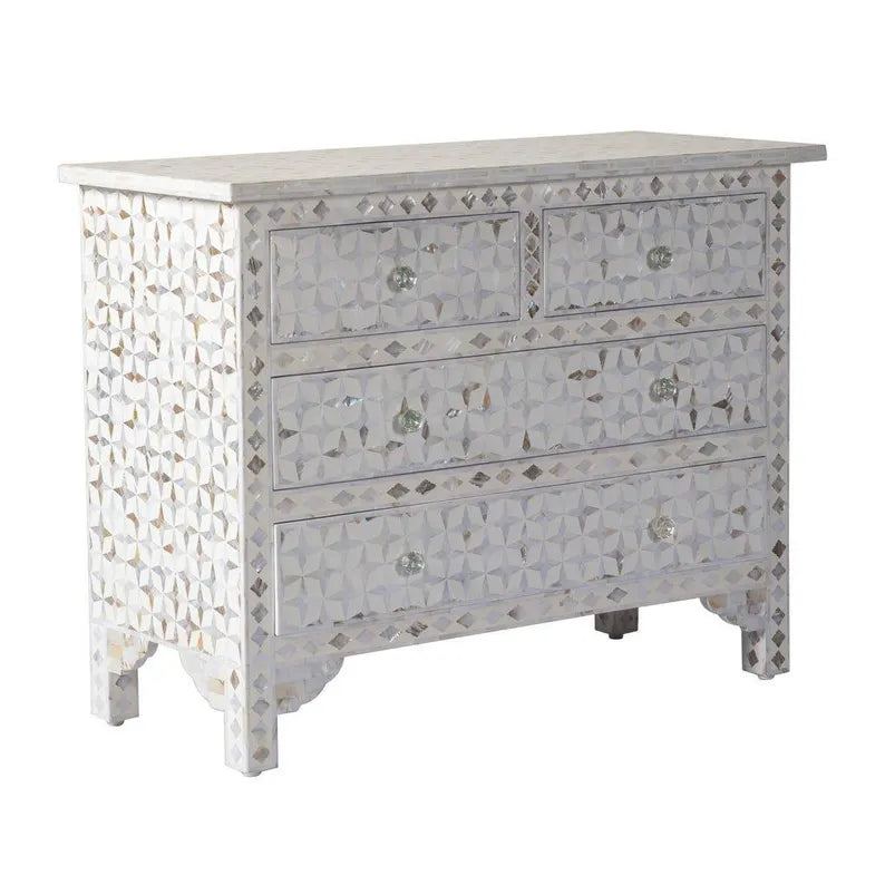 Decorative chest of drawers with shell inlay in a room setting.