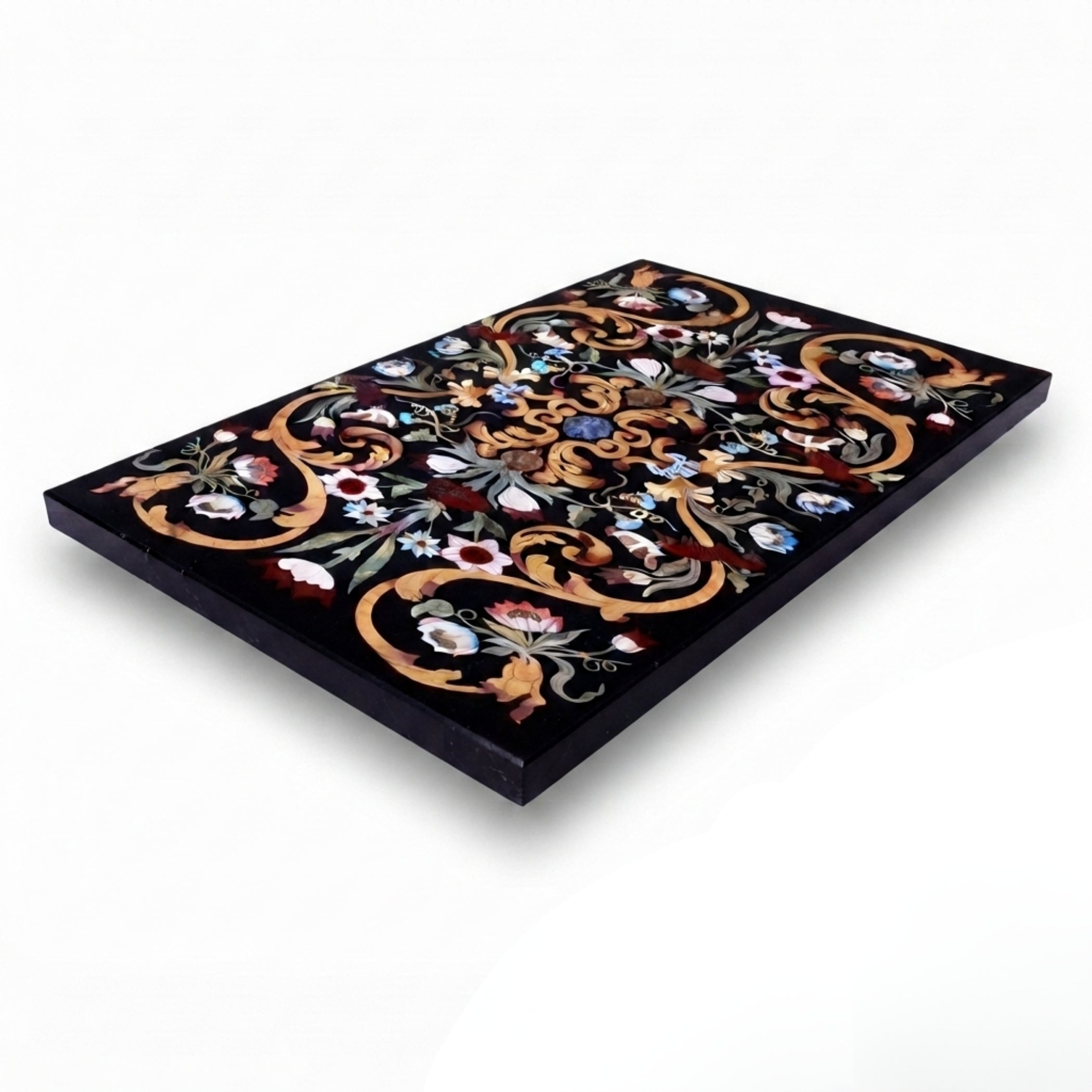 Angled view of a handmade rectangular black marble table top with luxury floral Pietra Dura gemstone inlay on a white background.