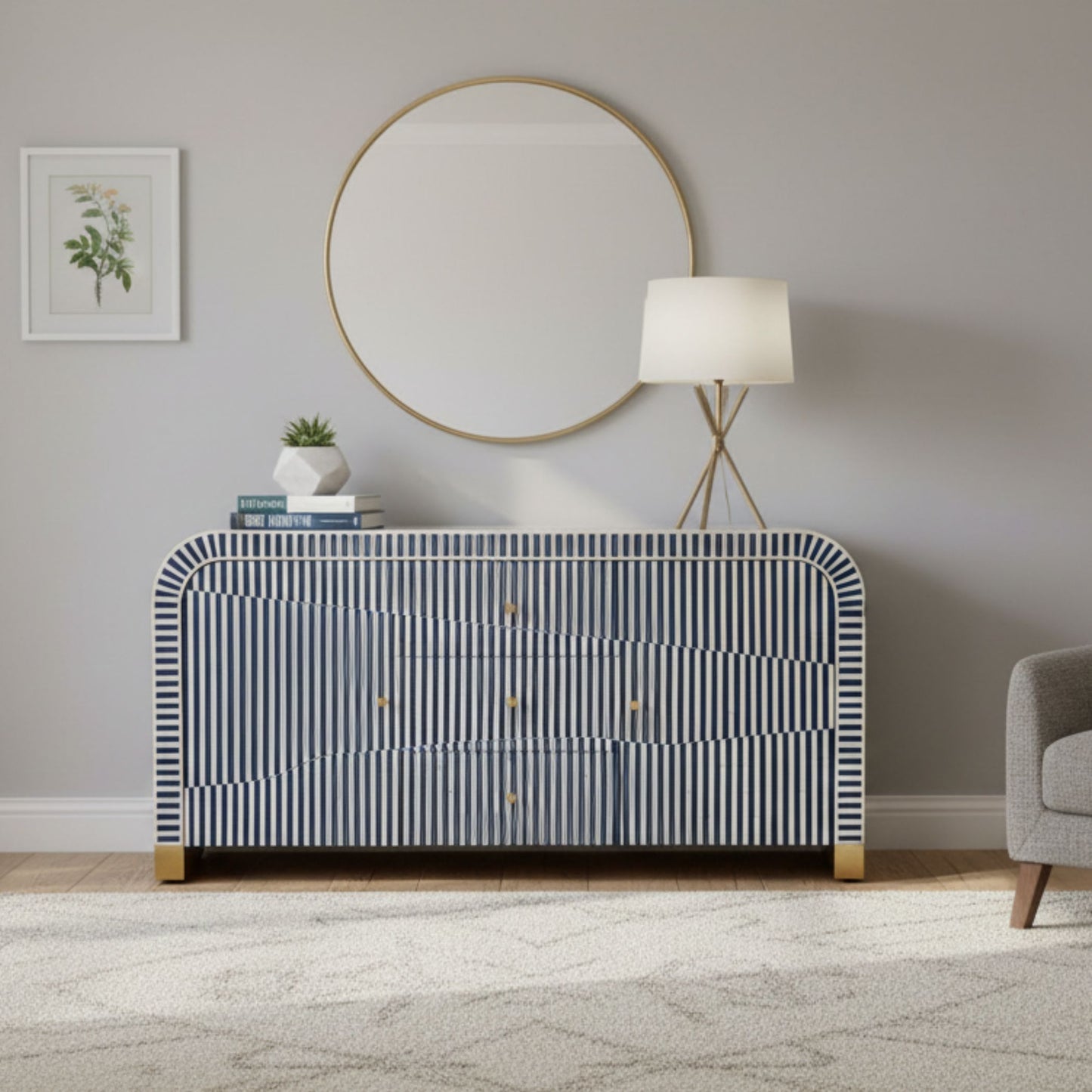 Modern interior with a striped dresser, round mirror, and lamp.