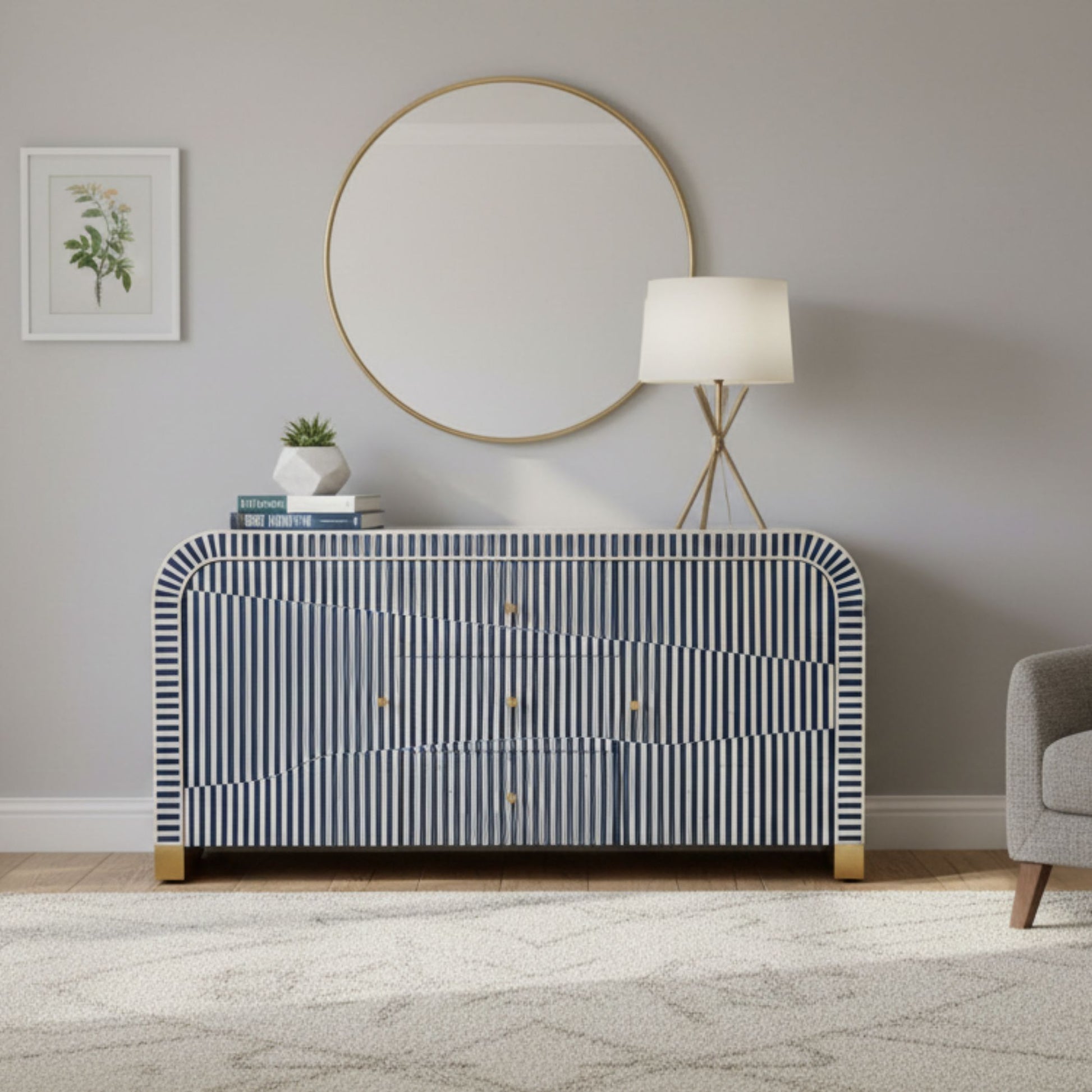 Modern interior with a striped dresser, round mirror, and lamp.