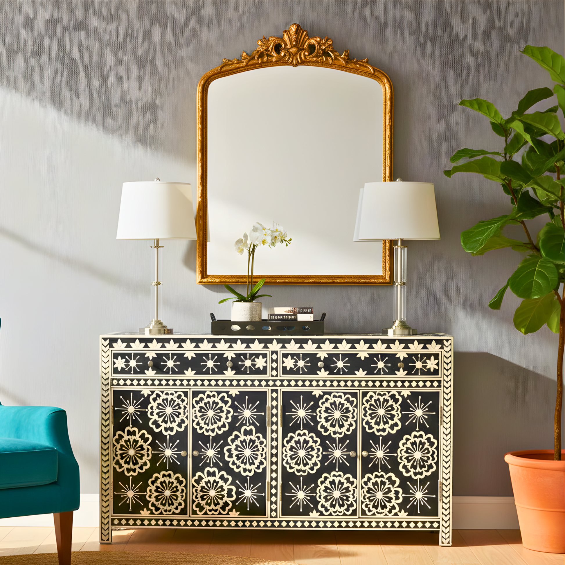 Decorative console table with floral patterns, gold-framed mirror, and lamps in a room setting.