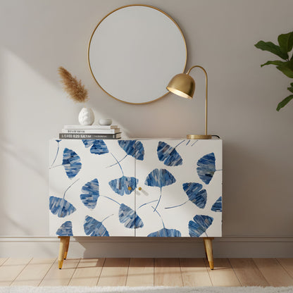 Cabinet with blue leaf pattern in a room with a mirror and lamp.