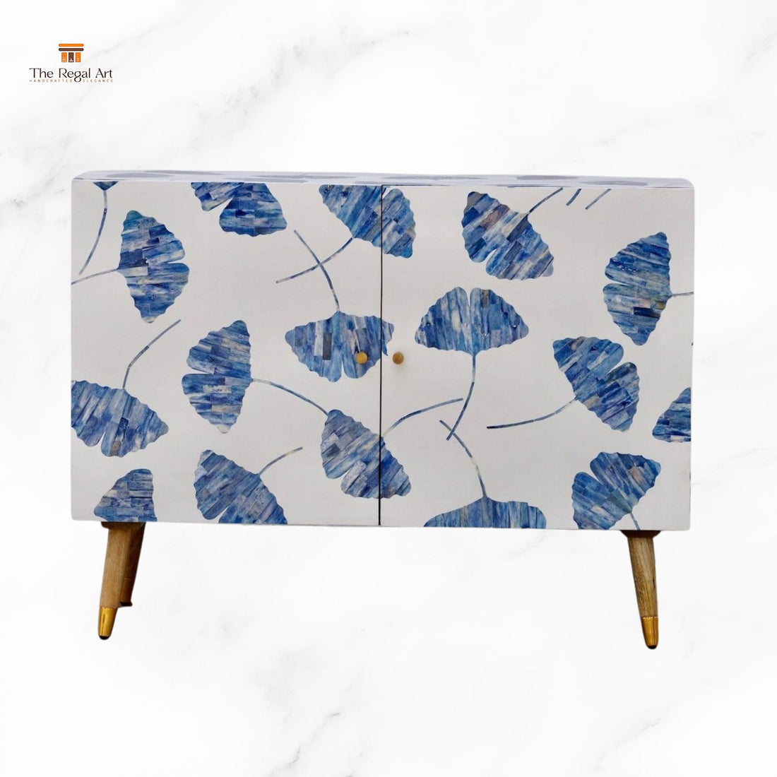 Cabinet with blue leaf pattern in a room with a mirror and lamp.
