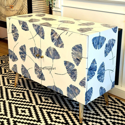 Cabinet with blue leaf pattern on a black and white geometric rug