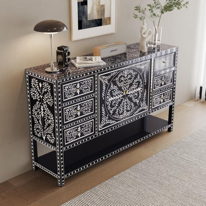 Decorative black and white sideboard in a room with a lamp and decor the regal art items.