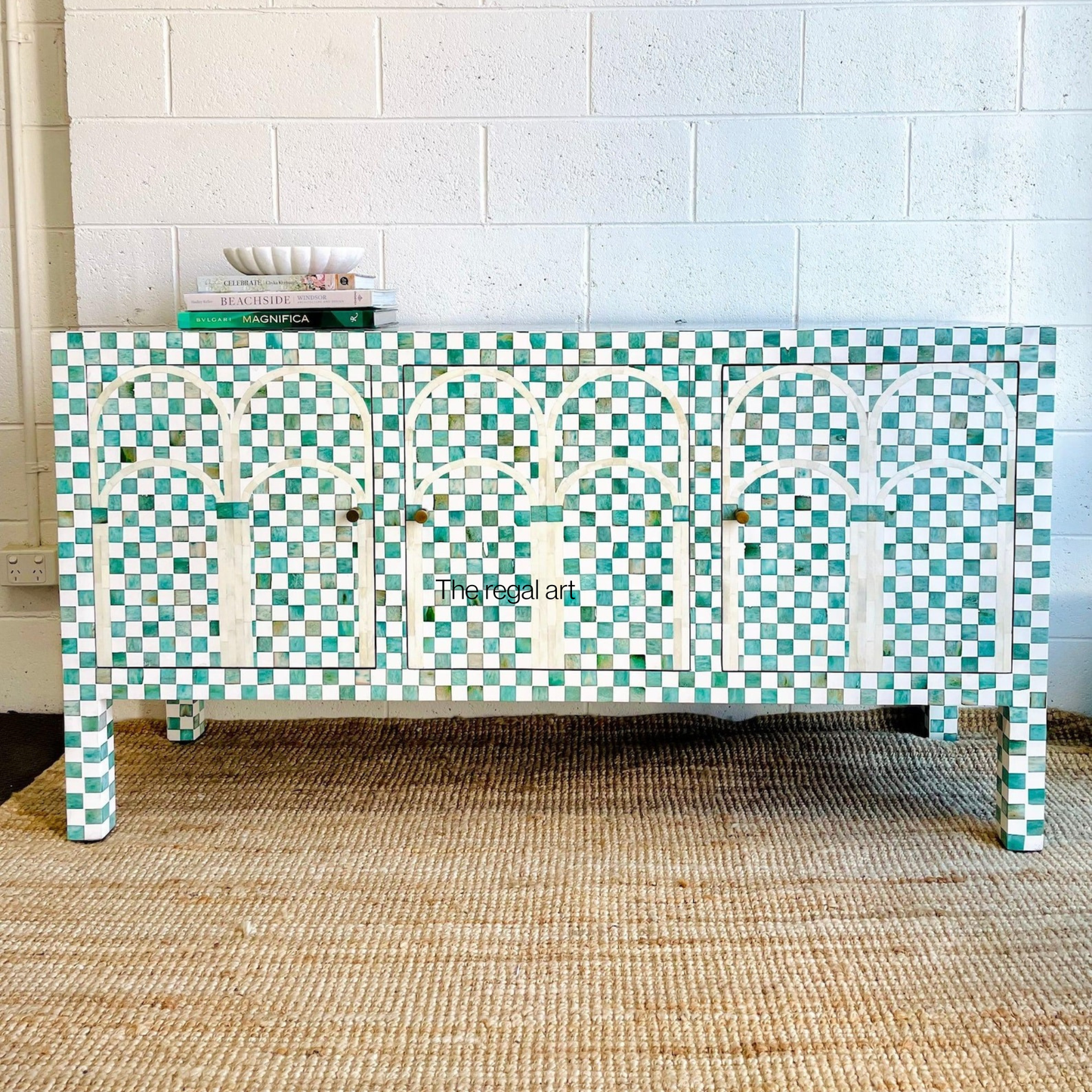 Decorative sideboard with a geometric pattern in a room with tiled walls.