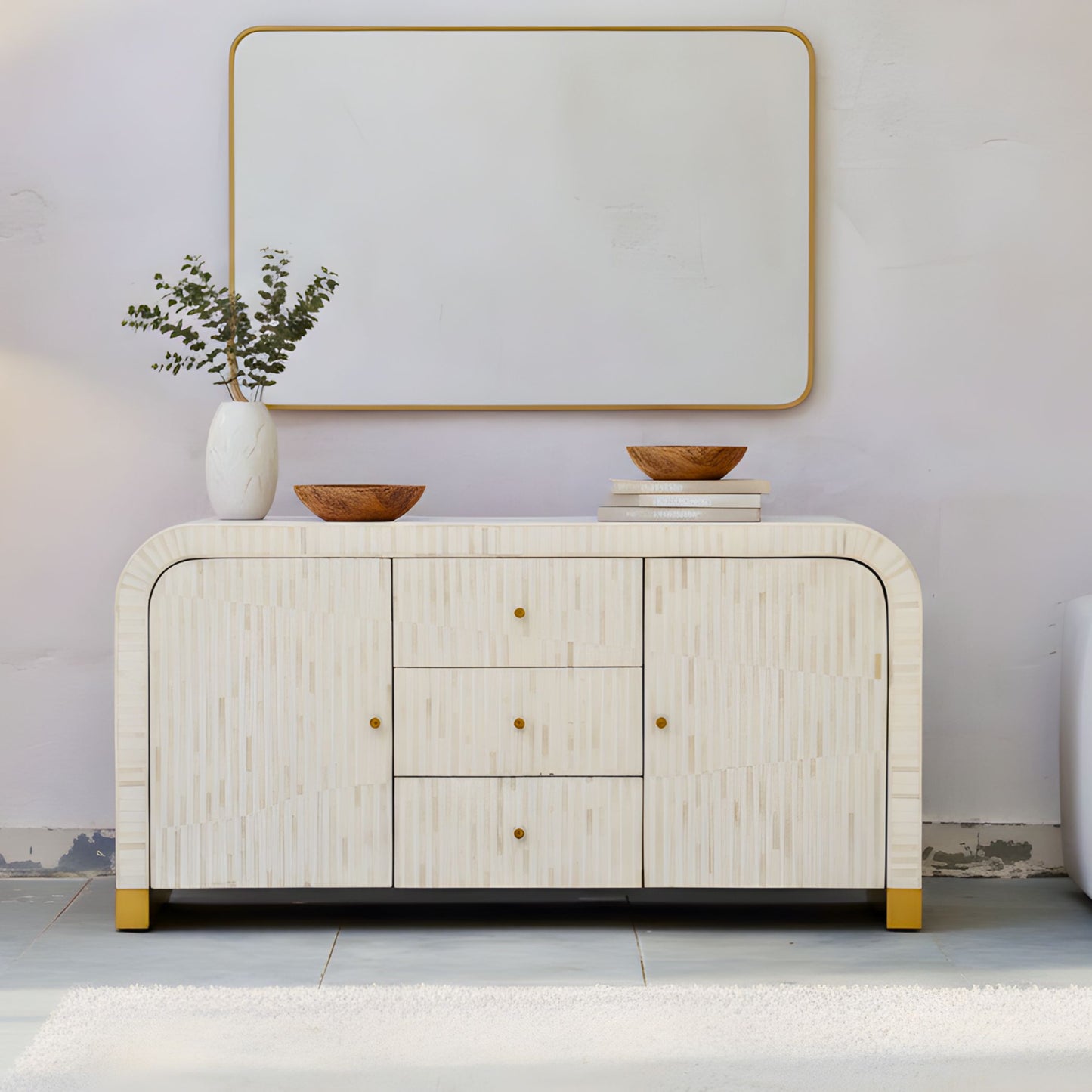 Modern sideboard with decorative items against a plain wall