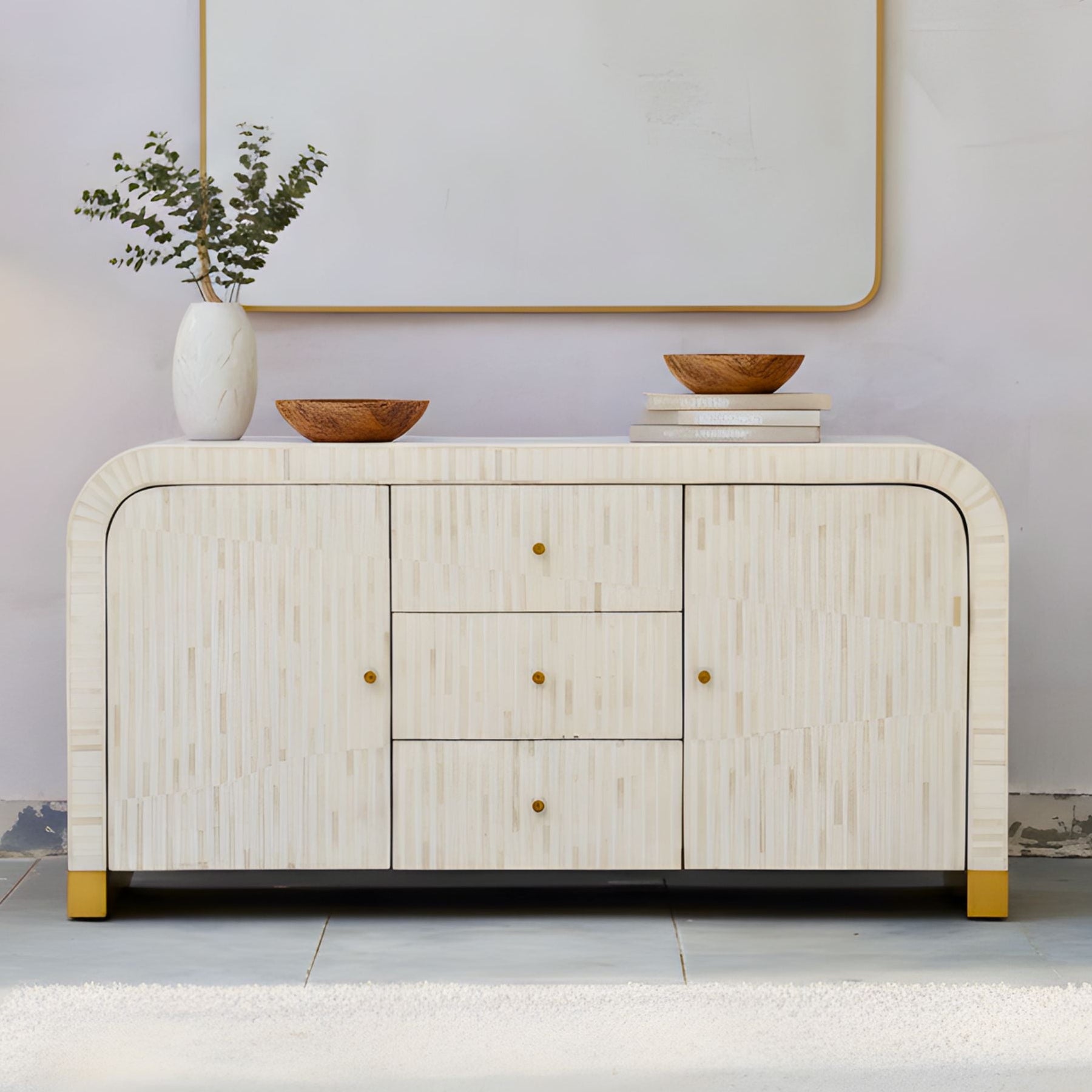 Modern sideboard with decorative items against a plain wall